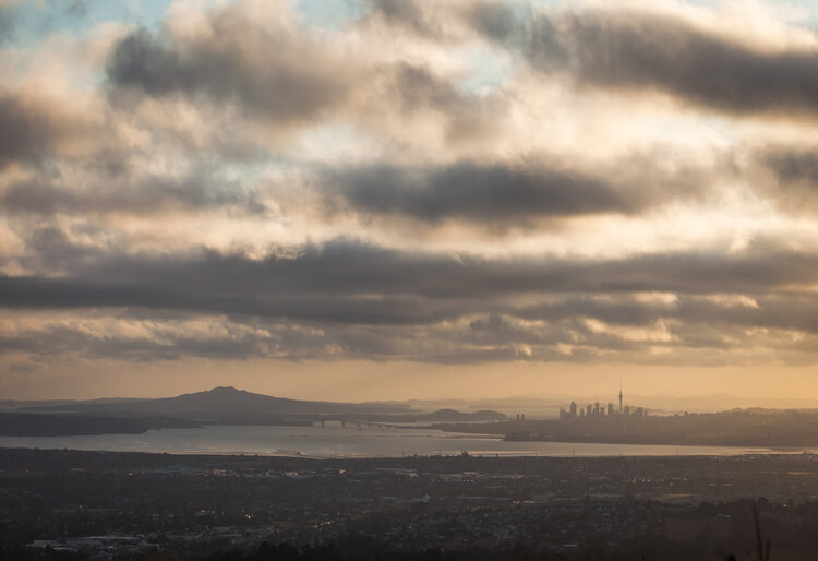 Photo of a cloudy Auckland with the Sky Tower in the background